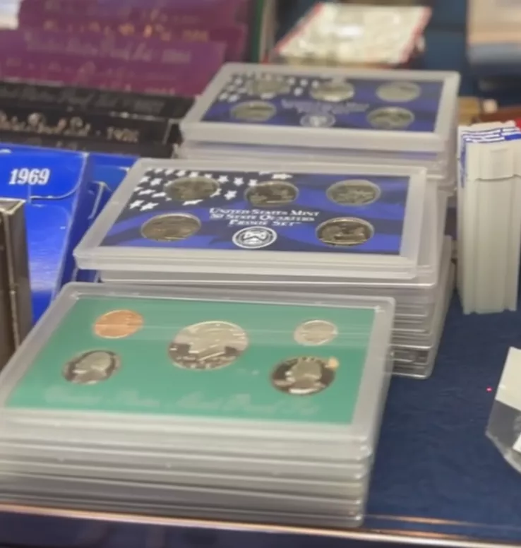 Coin expert appraising gold and silver coins at Gold Mind Jewelers Sharon