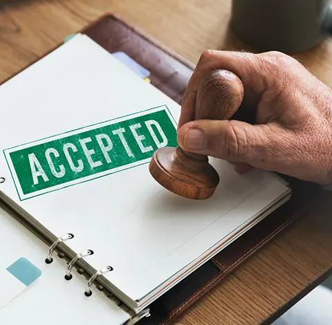 Expert evaluating antique jewelry and collectibles at Gold Mind Jewelers Sharon